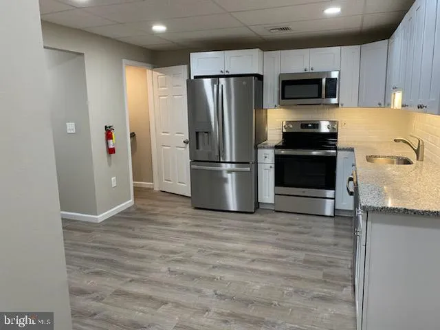 a kitchen with stainless steel appliances a refrigerator stove and microwave