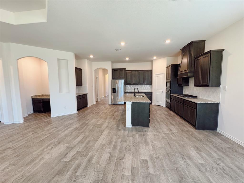1076 Sublime Drive Forney, TX 75126 - Photo 15 of 40 a large kitchen with cabinets and stainless steel appliances
