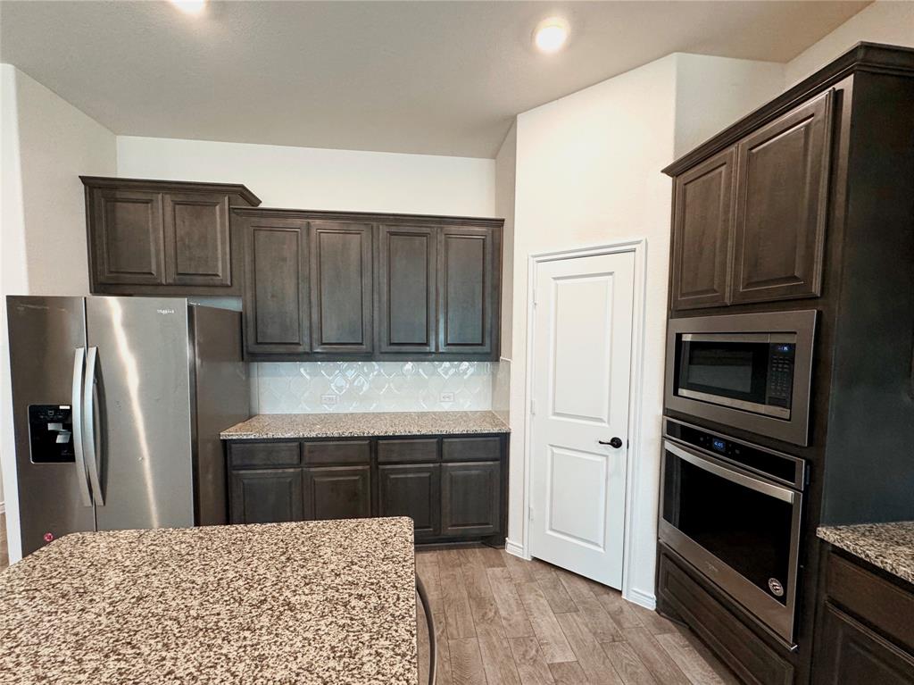 1076 Sublime Drive Forney, TX 75126 - Photo 17 of 40 a kitchen with a refrigerator and a sink