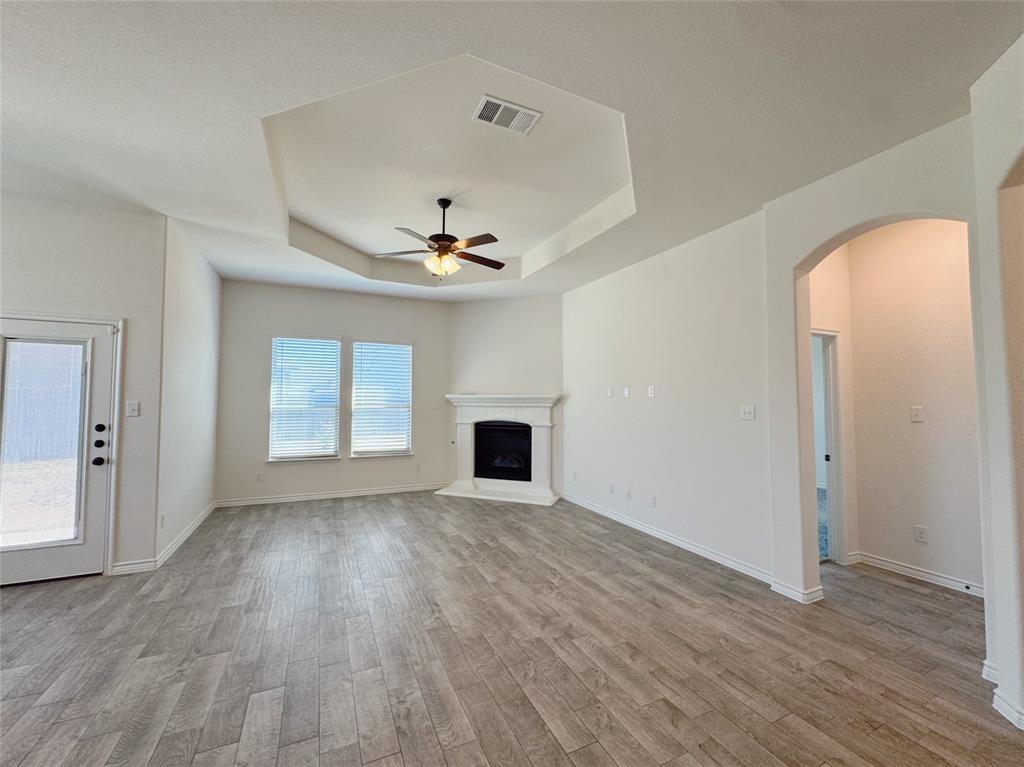 1076 Sublime Drive Forney, TX 75126 - Photo 21 of 40 a view of a livingroom with a fireplace wooden floor and windows