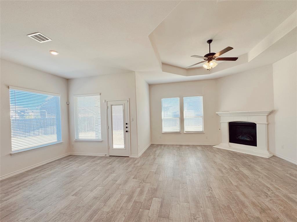 1076 Sublime Drive Forney, TX 75126 - Photo 22 of 40 a view of an empty room with a window and wooden floor