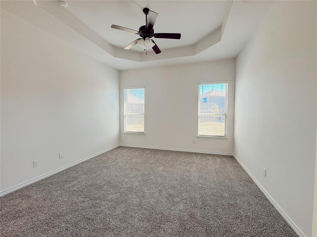 1076 Sublime Drive Forney, TX 75126 - Photo 27 of 40 an empty room with a ceiling fan and window