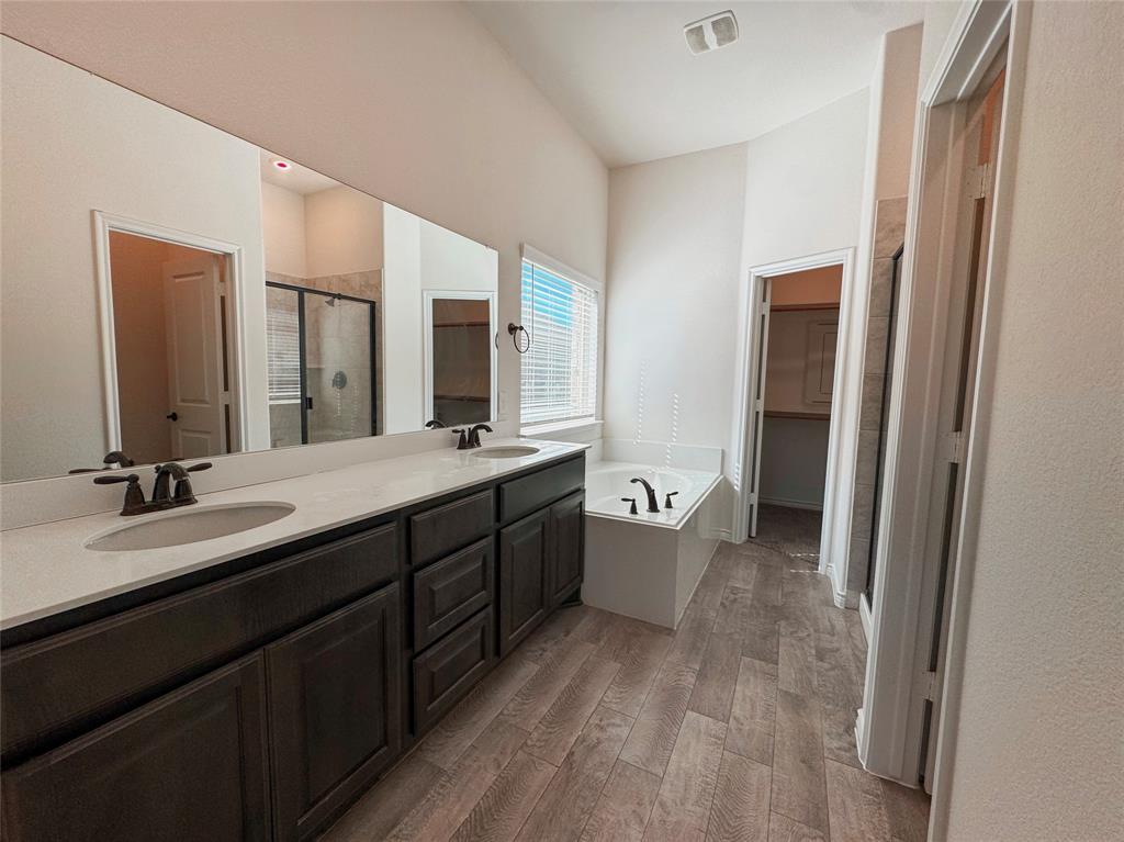 1076 Sublime Drive Forney, TX 75126 - Photo 28 of 40 a spacious bathroom with a double vanity sink a mirror and a bathtub