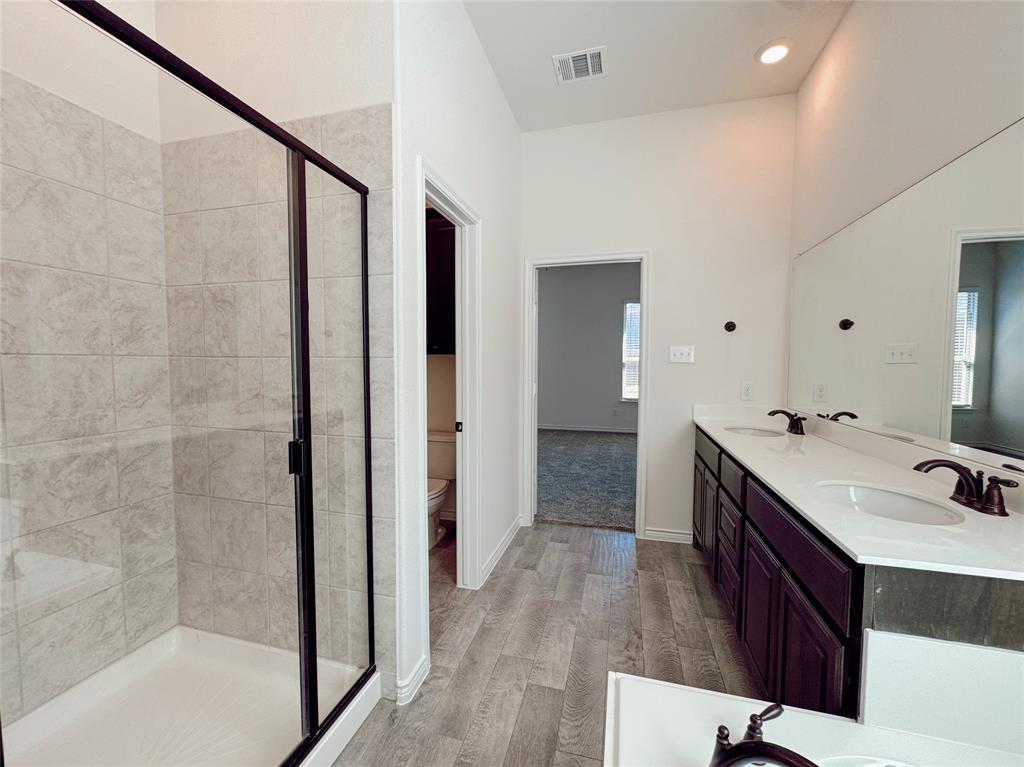 1076 Sublime Drive Forney, TX 75126 - Photo 30 of 40 a bathroom with a double vanity sink a mirror and shower