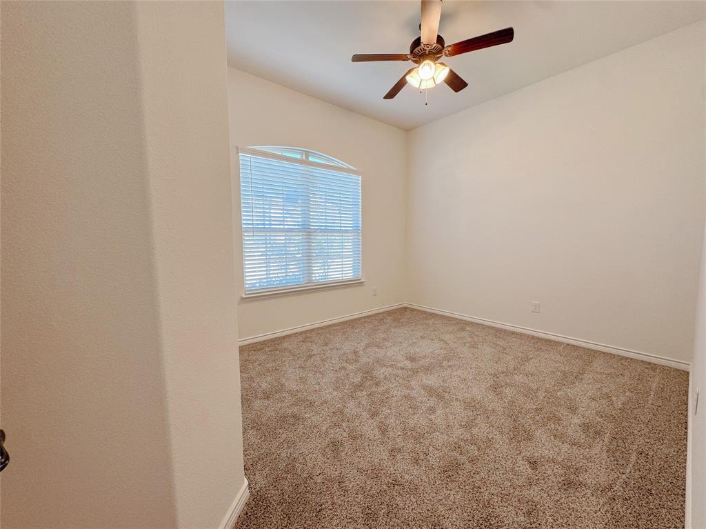 1076 Sublime Drive Forney, TX 75126 - Photo 9 of 40 an empty room with windows and fan
