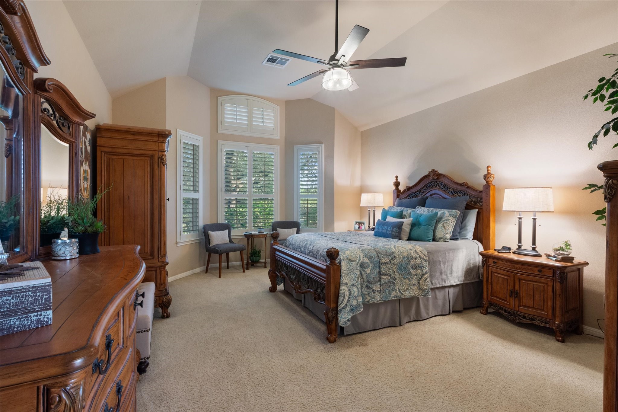 5421 Cypress Ranch Boulevard Spicewood, TX 78669 - Photo 14 of 42 a bedroom with a bed a chandelier and a large window