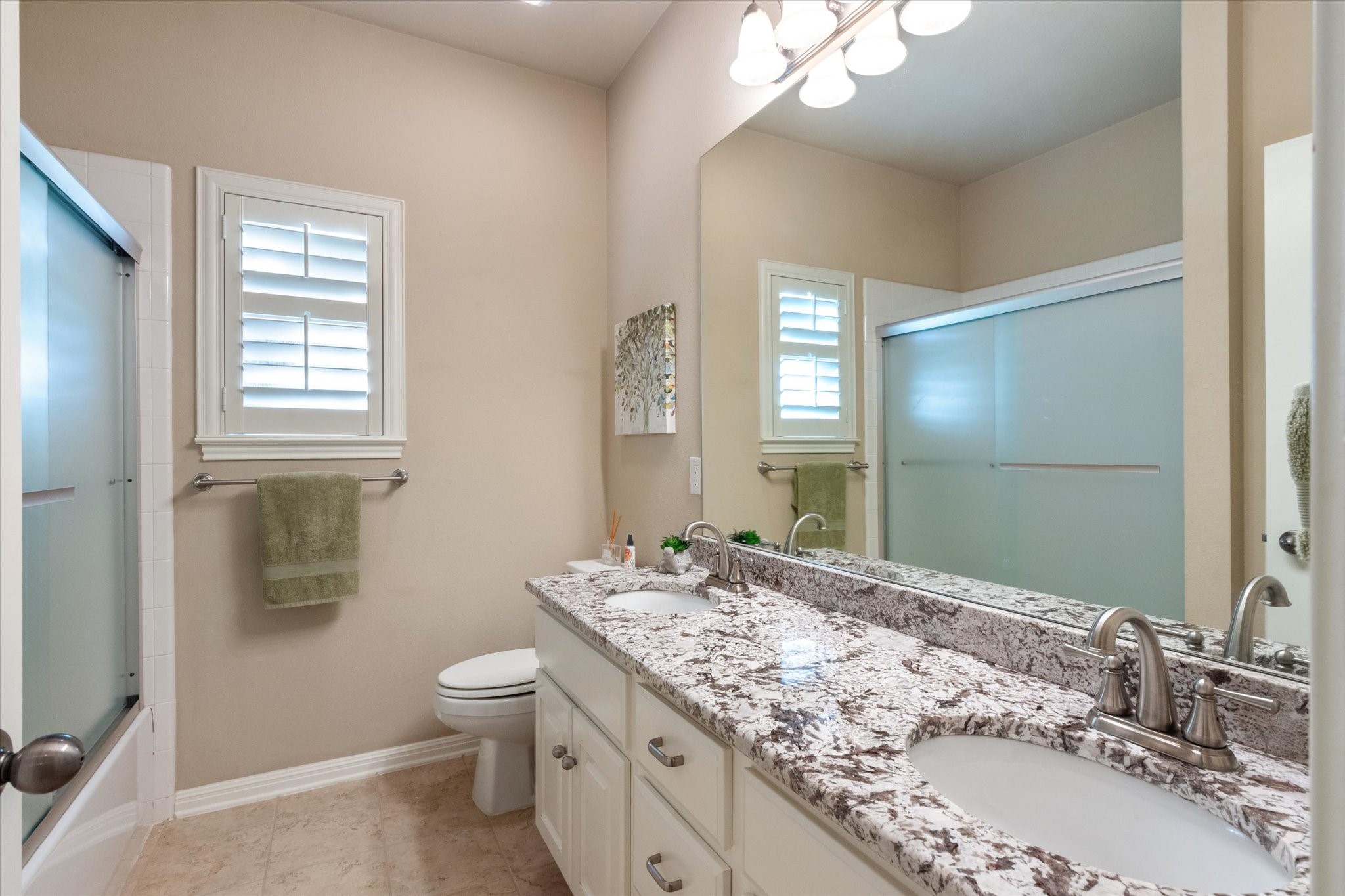 5421 Cypress Ranch Boulevard Spicewood, TX 78669 - Photo 20 of 42 a bathroom with a granite countertop sink a toilet and a mirror