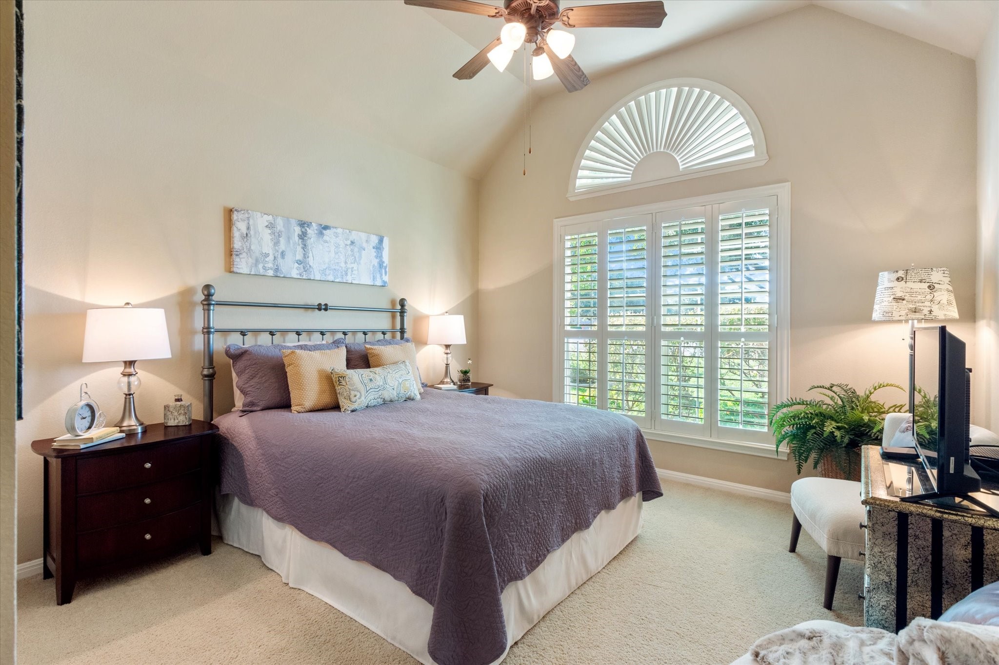 5421 Cypress Ranch Boulevard Spicewood, TX 78669 - Photo 21 of 42 a bedroom with a bed and a chandelier