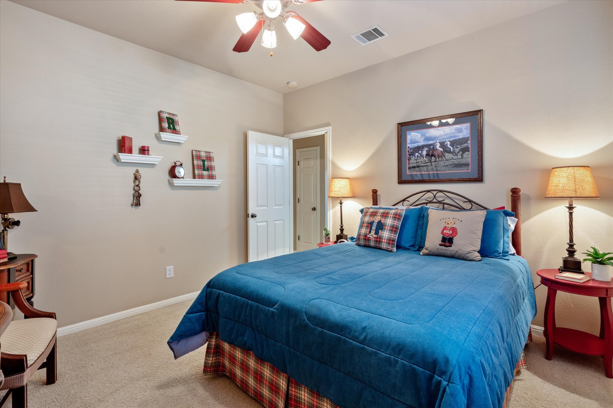 5421 Cypress Ranch Boulevard Spicewood, TX 78669 - Photo 23 of 42 a bedroom with a bed and a chandelier