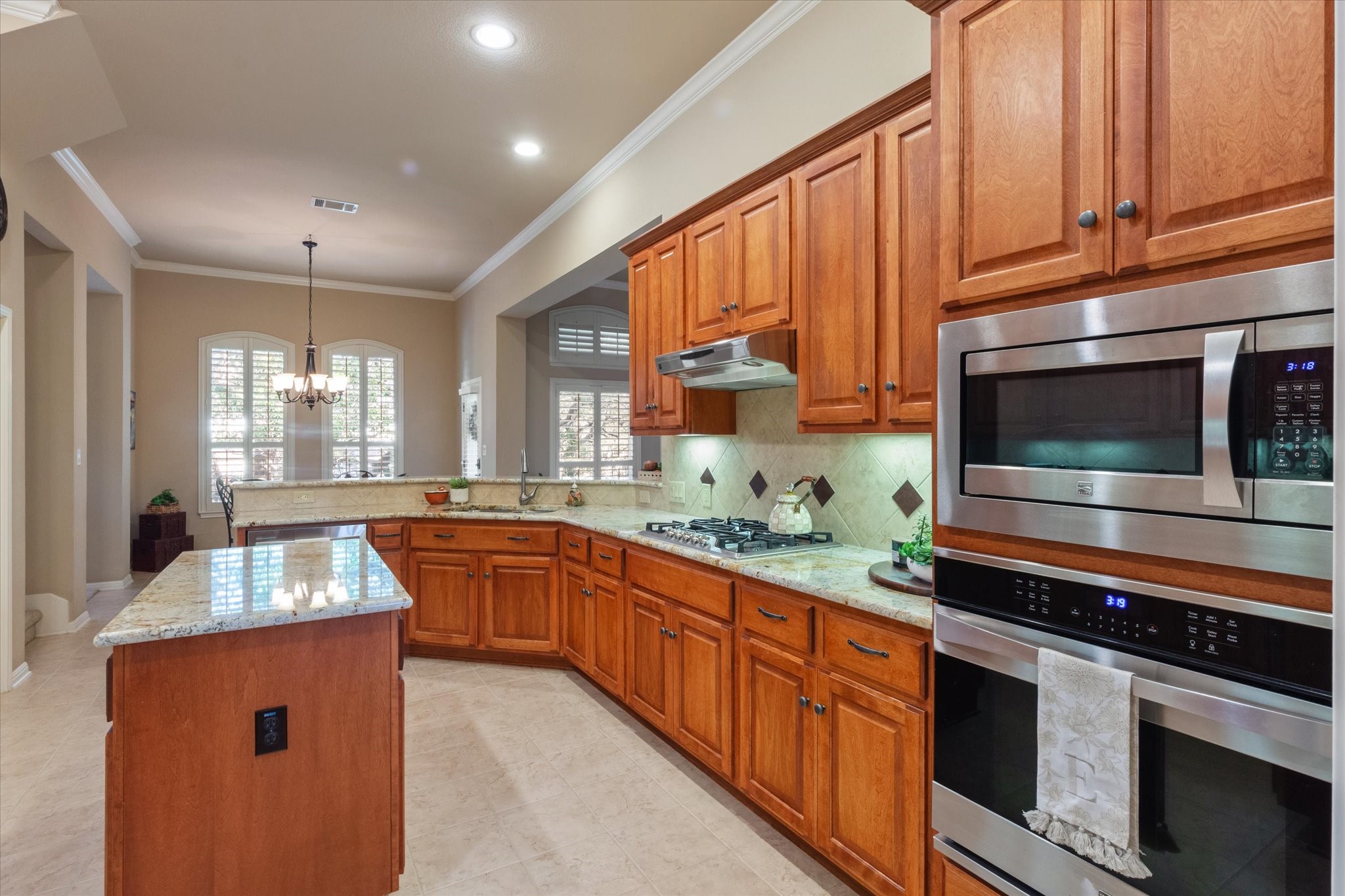 5421 Cypress Ranch Boulevard Spicewood, TX 78669 - Photo 7 of 42 a kitchen with stainless steel appliances granite countertop a sink and a stove