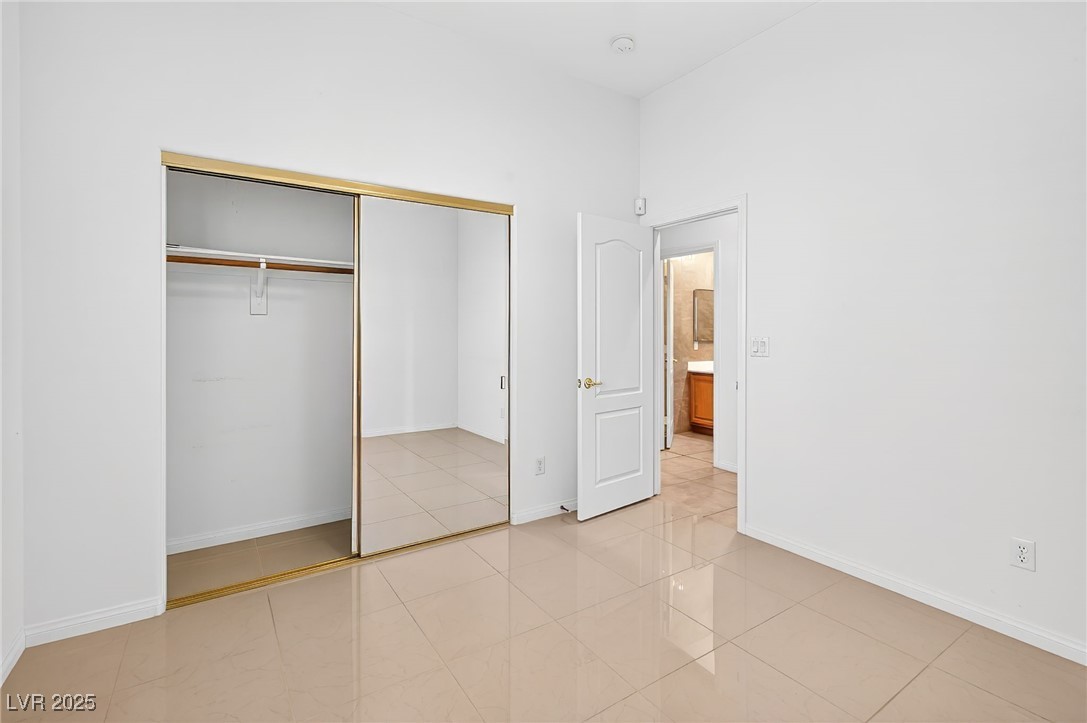 1028 Triumphant Street Henderson, NV 89052 - Photo 18 of 51 Bedroom with a closet and light tile patterned floors