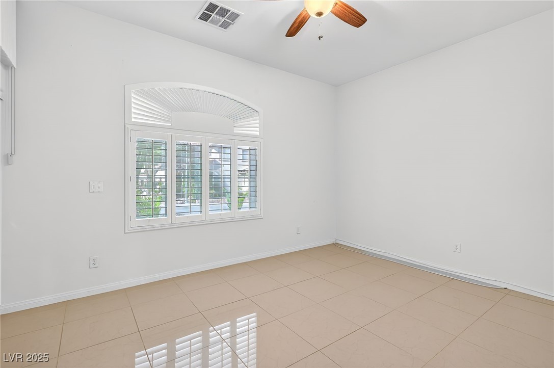 1028 Triumphant Street Henderson, NV 89052 - Photo 19 of 51 Bedroom featuring ceiling fan and light tile patterned flooring