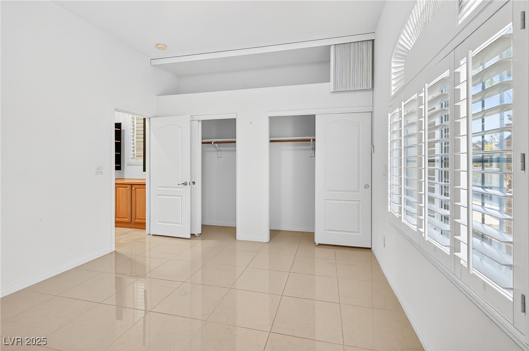 1028 Triumphant Street Henderson, NV 89052 - Photo 20 of 51 Bedroom featuring multiple closets and light tile patterned floors