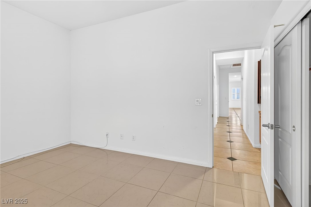 1028 Triumphant Street Henderson, NV 89052 - Photo 21 of 51 Bedroom featuring light tile patterned floors and baseboards