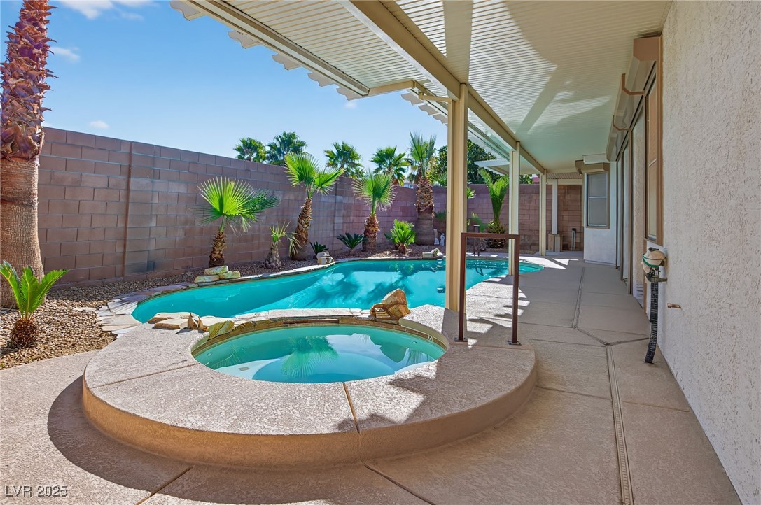 1028 Triumphant Street Henderson, NV 89052 - Photo 36 of 51 View of swimming pool with a fenced backyard, a patio, and a pool with connected hot tub