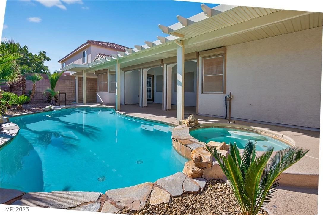 1028 Triumphant Street Henderson, NV 89052 - Photo 40 of 51 View of pool with a patio area, a pergola, and a pool with connected hot tub