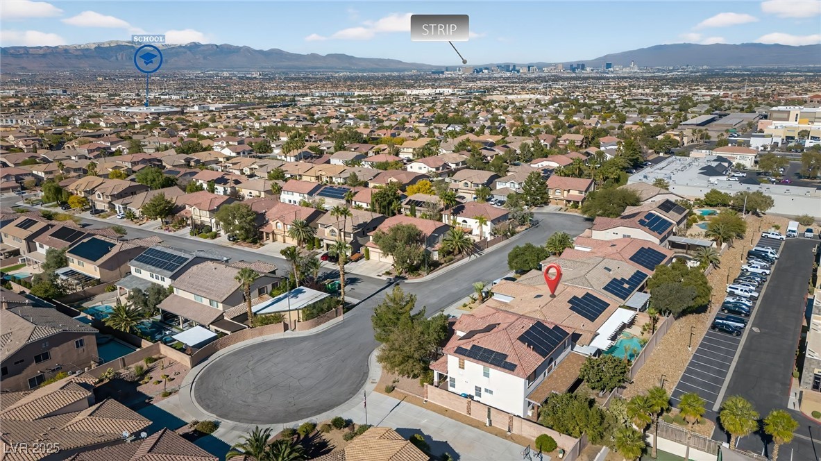 1028 Triumphant Street Henderson, NV 89052 - Photo 42 of 51 Aerial view of property and surrounding area with a mountainous background and nearby suburban area