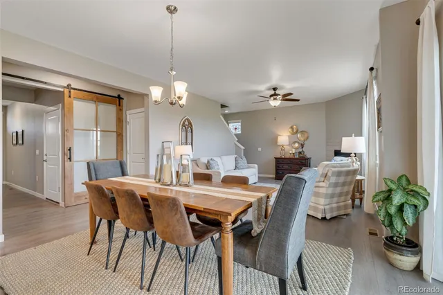 a view of a dining room with furniture and a chandelier