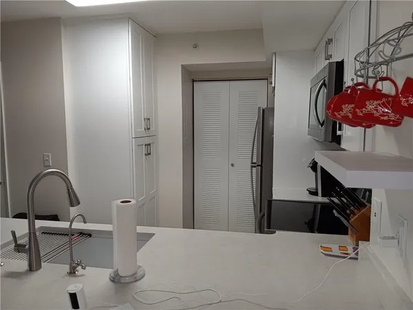 a bedroom with a bed and teddy bear on the dresser