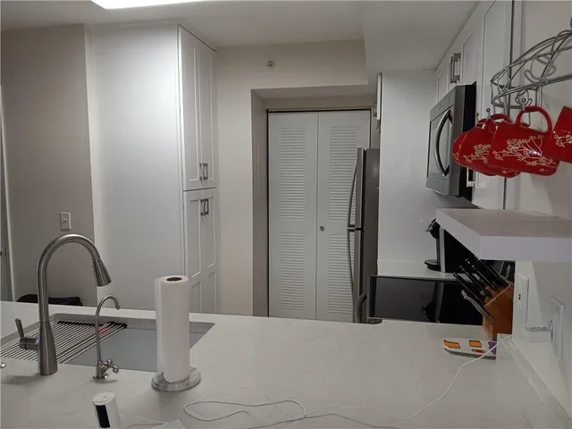 a bedroom with a bed and teddy bear on the dresser