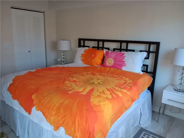 a large bed sitting in a bedroom next to a bathroom