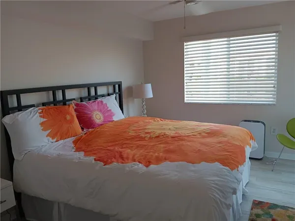 a bed sitting in a bedroom next to a window