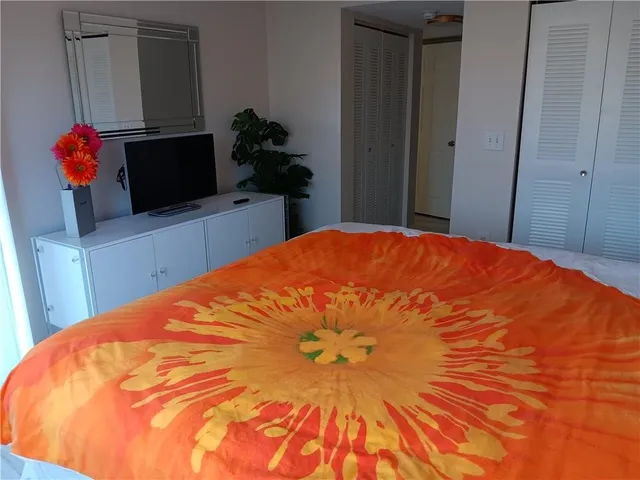 a bed sitting in a bedroom and a mirror