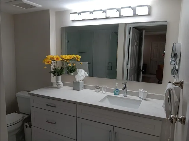 a bathroom with a sink double vanity and a mirror