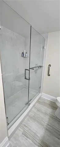 a bathroom with a glass shower door