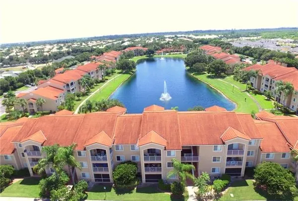 an aerial view of residential houses with outdoor space and river view