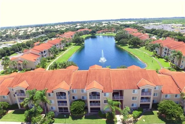 an aerial view of residential houses with outdoor space and river view