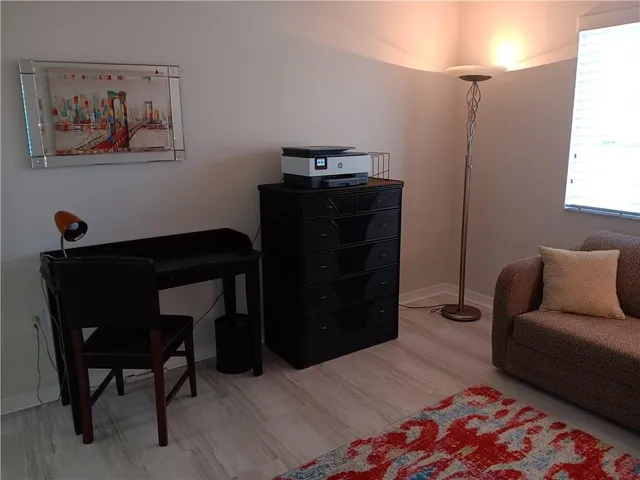a bedroom with a bed and a desk