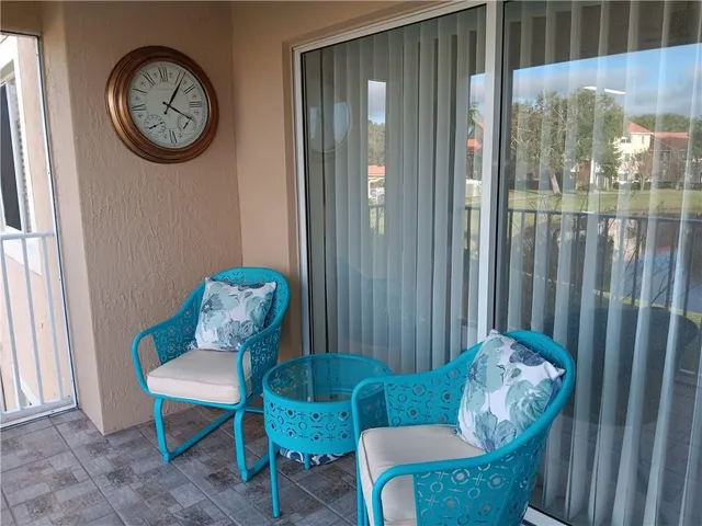 a view of a door and chair in the livingroom