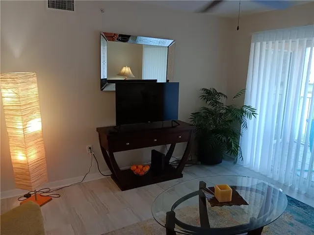 a living room with furniture and a potted plant