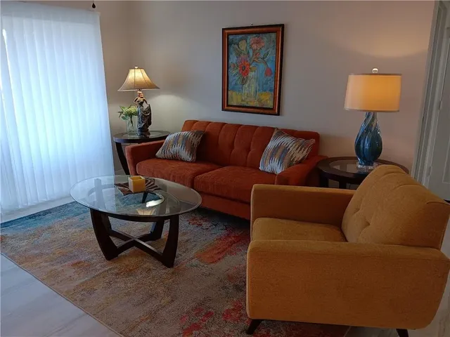 a living room with furniture and a lamp