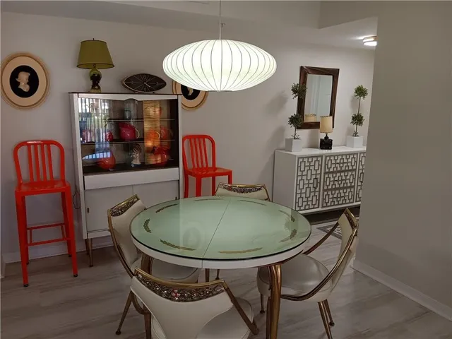 a dining room with furniture and window