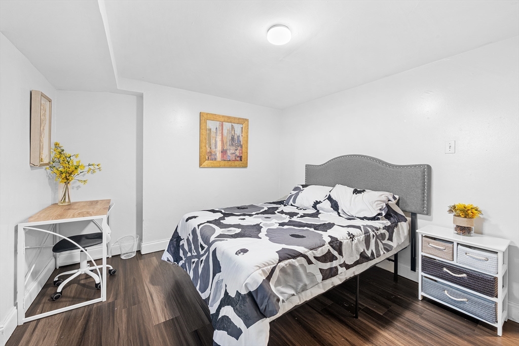 16 Mayfair Street Boston, MA 02119 - Photo 11 of 36 a bedroom with a bed and a table