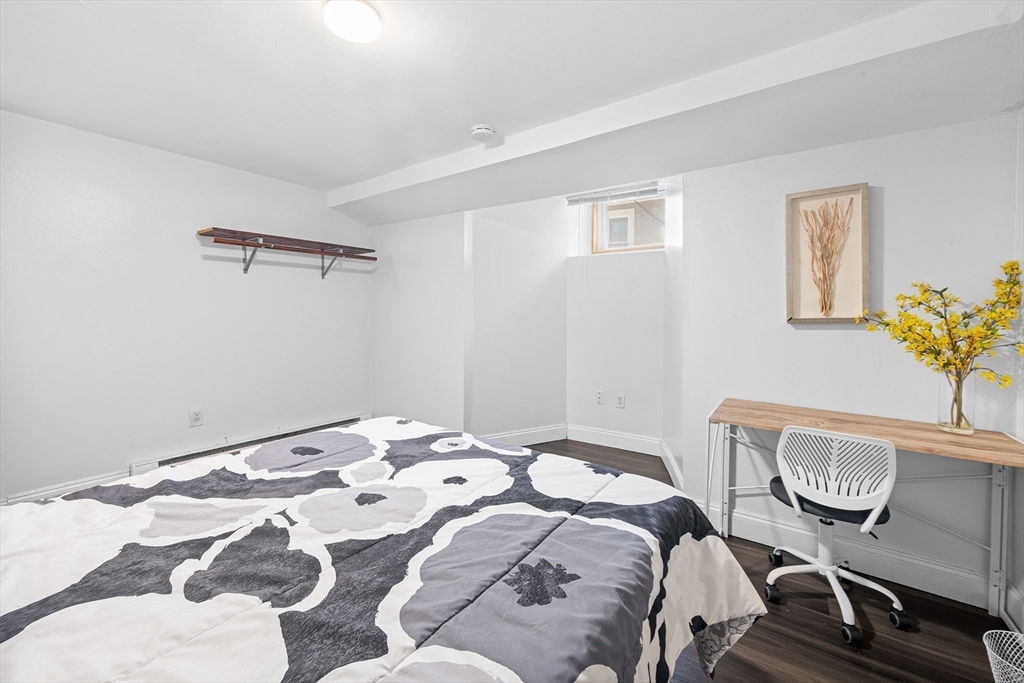 16 Mayfair Street Boston, MA 02119 - Photo 12 of 36 a bedroom with a bed and chair