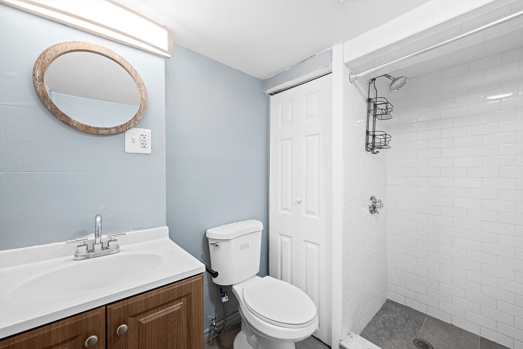 16 Mayfair Street Boston, MA 02119 - Photo 14 of 36 a bathroom with a toilet a sink a mirror and vanity