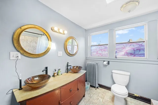 a bathroom with a toilet a sink and a mirror