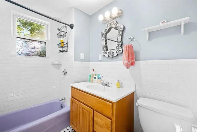 a bathroom with a sink a vanity and a bathtub