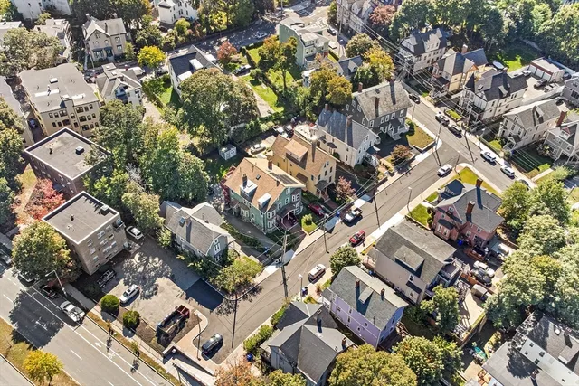 an aerial view of a residential apartment building with parking space