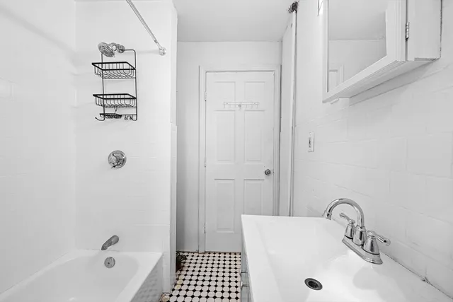 a bathroom with a sink a tub and a shower