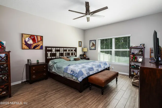 a bedroom with a bed and a television