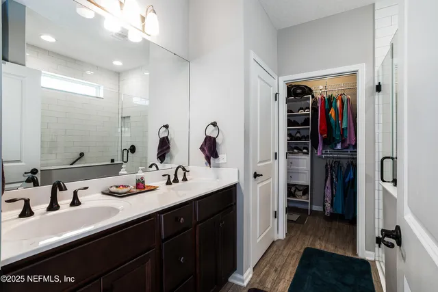 a bathroom with a double vanity sink and a mirror