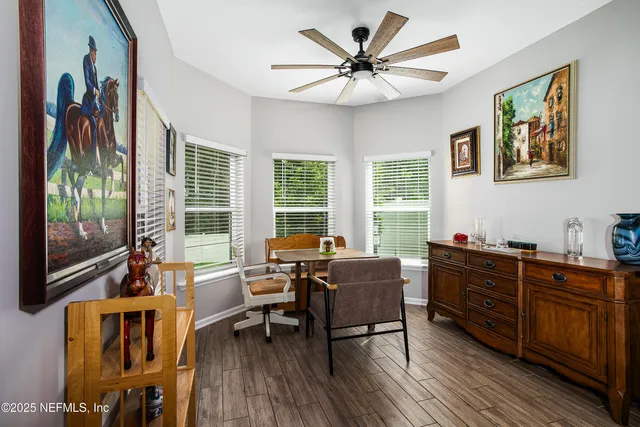 a view of a workspace with furniture and a window