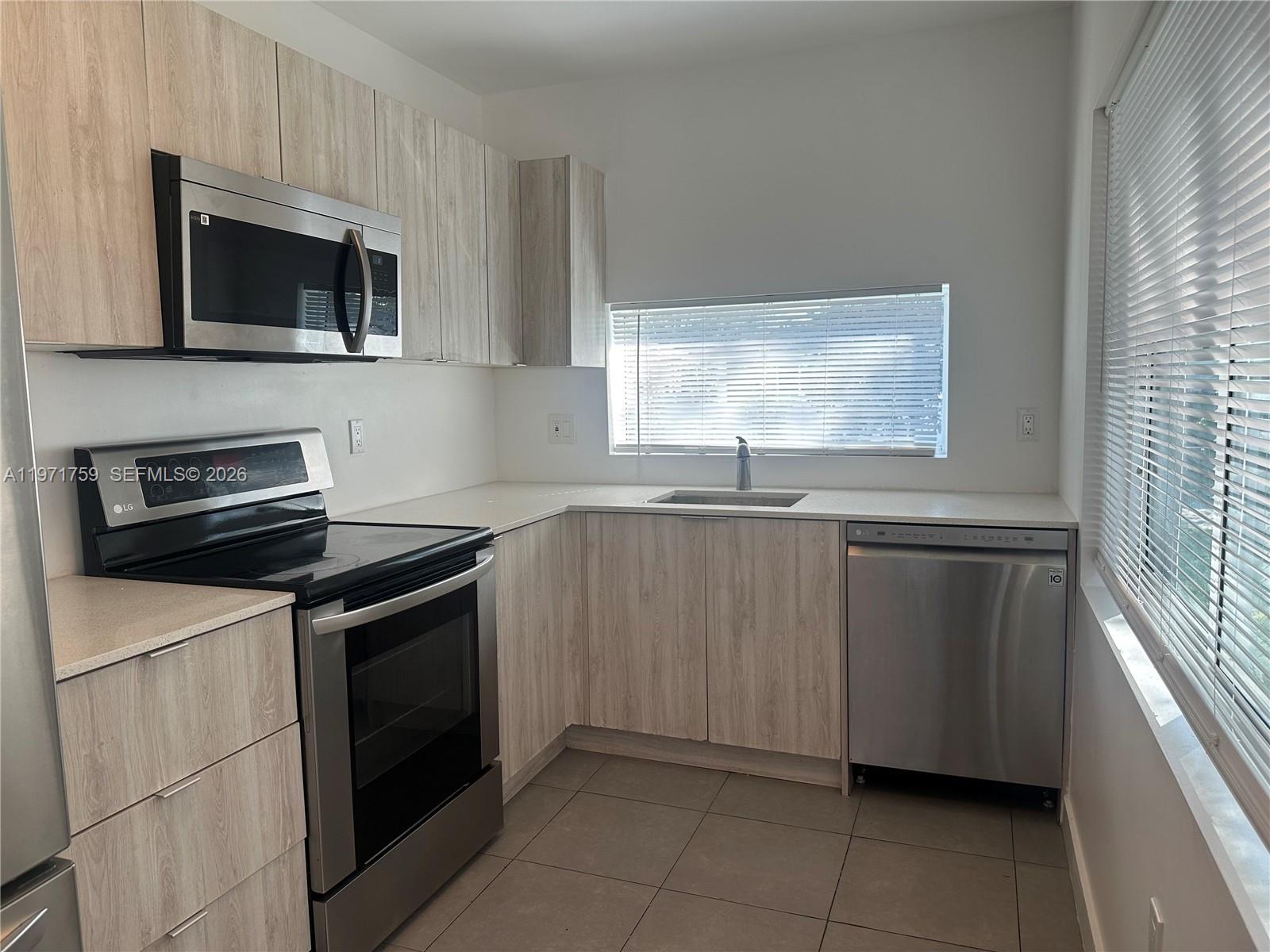 2206 Simms Street Hollywood, FL 33020 - Photo 12 of 23 a kitchen with granite countertop a sink and a stove top oven