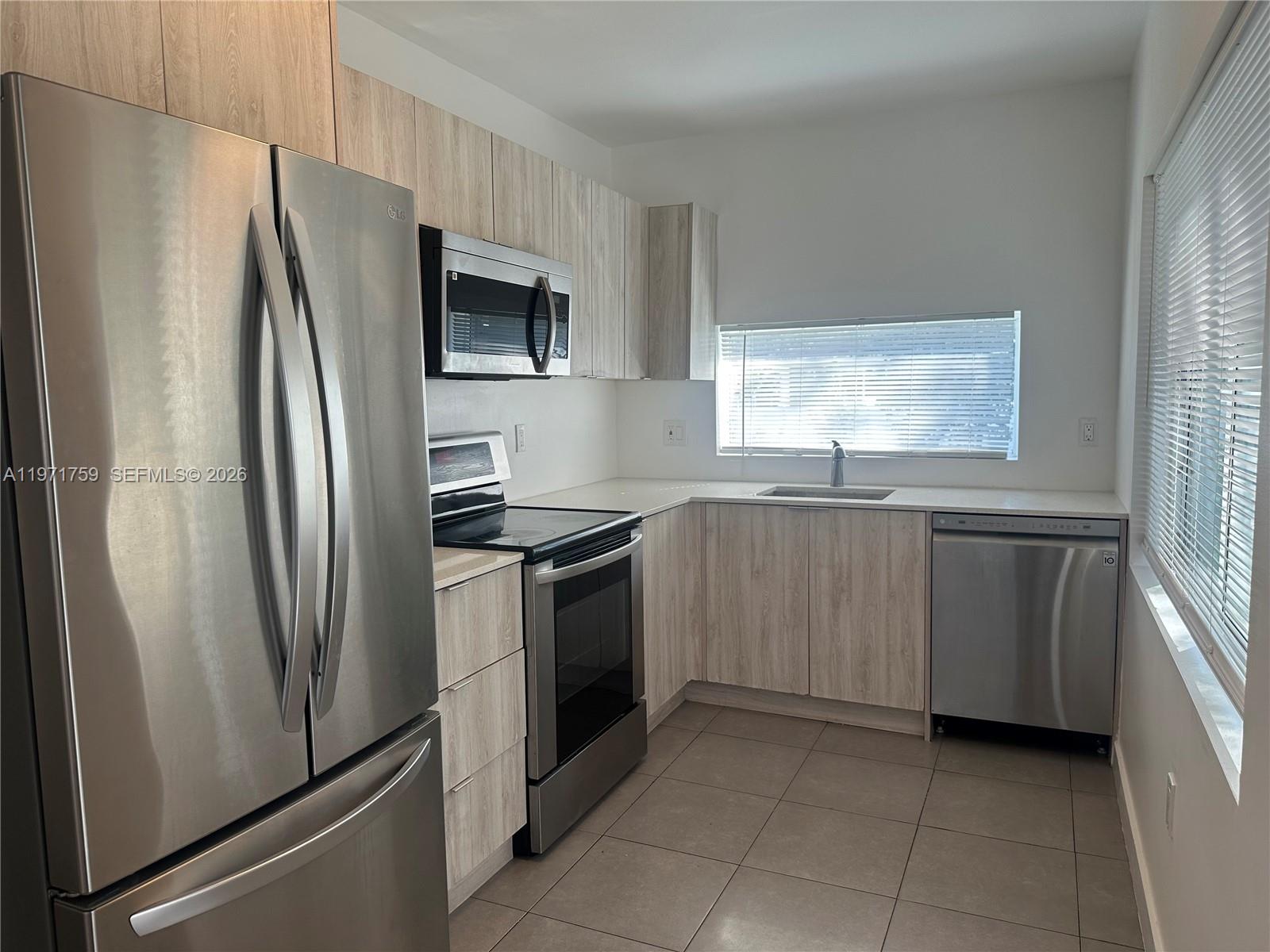 2206 Simms Street Hollywood, FL 33020 - Photo 14 of 23 a kitchen with stainless steel appliances granite countertop a refrigerator and a sink