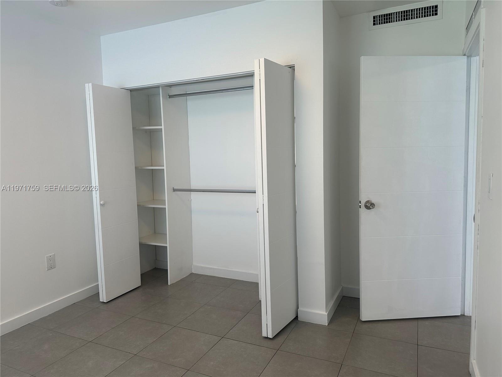 2206 Simms Street Hollywood, FL 33020 - Photo 4 of 23 a view of walk in closet with empty racks