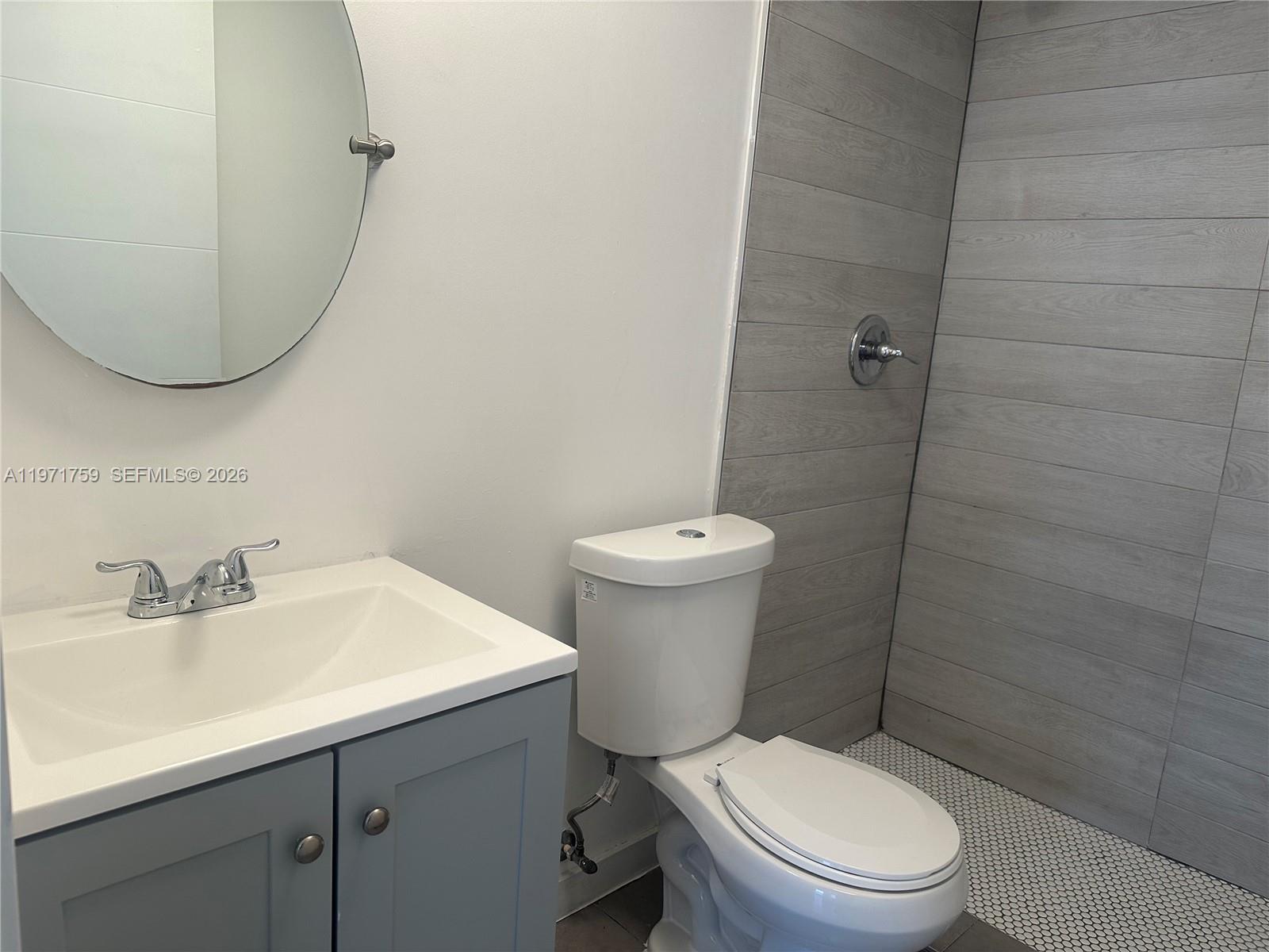 2206 Simms Street Hollywood, FL 33020 - Photo 6 of 23 a white toilet sitting next to a bathroom sink